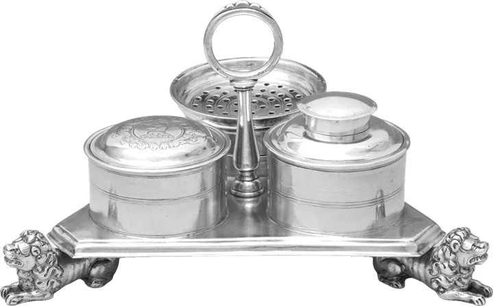 A silver inkstand on lion-paw feet