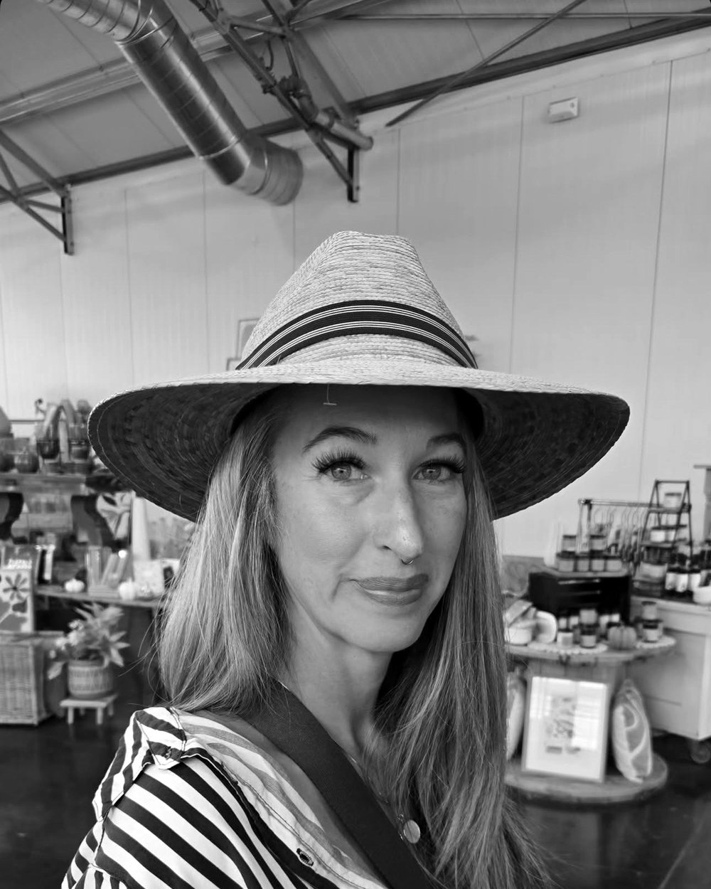 Amanda Porter in a wide-brimmed sun hat and a striped shirt